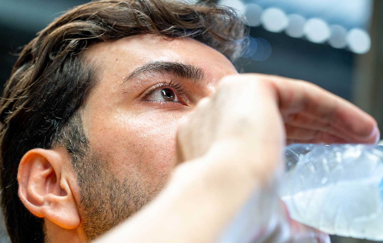 Young male drinking from water bottle