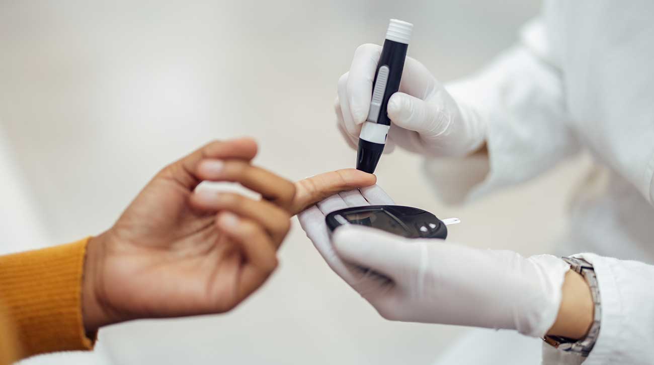 Doctor checking patients blood sugar levels