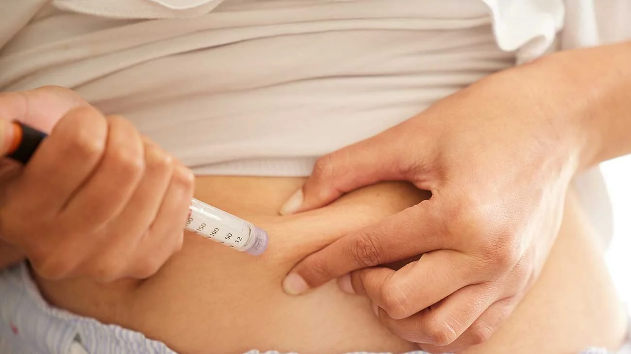 Person injecting themselves with an insulin pen