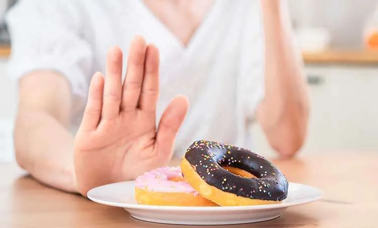 Female avoiding donut on a dish