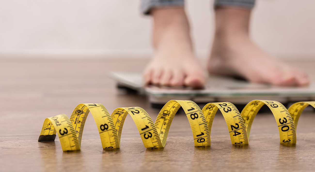 Feet on scale measuring weight