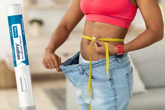 Woman measuring her waist after substantial weight loss | Wegovy Before and After